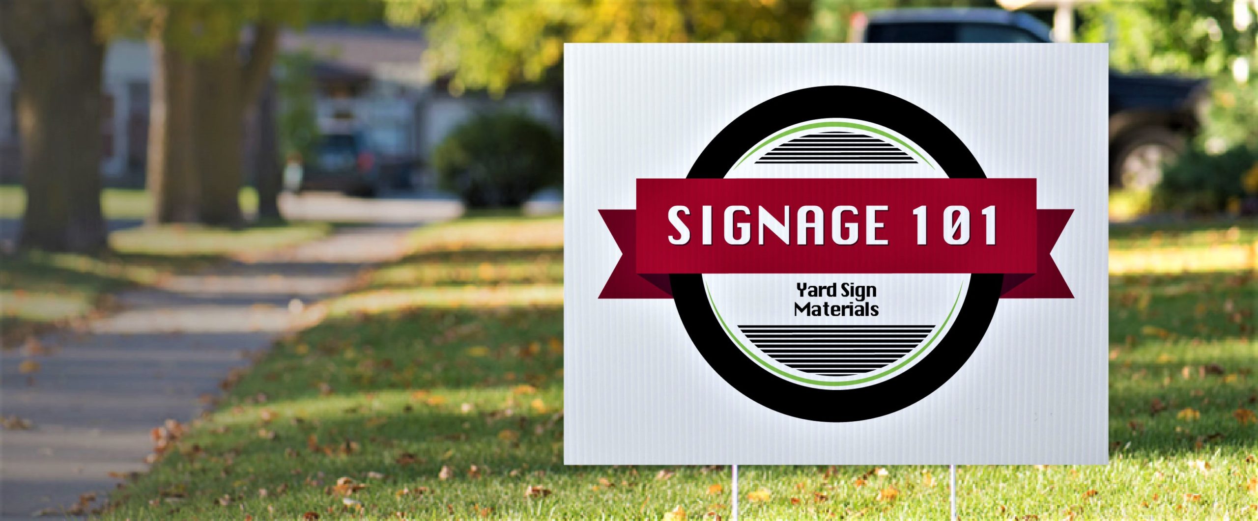 plastic yard sign with 'Signage 101' logo in a grass field